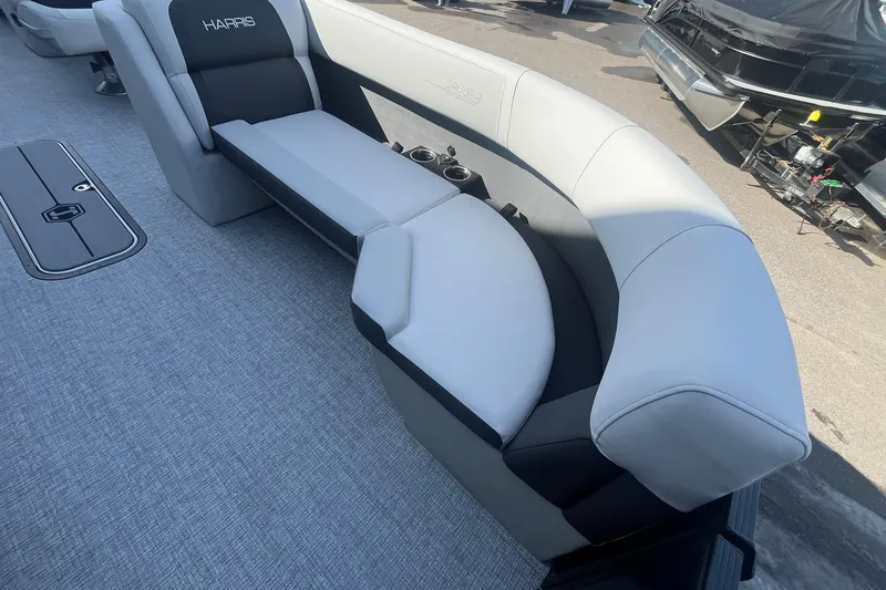 Slide: The Image of 2026 Harris Cruiser 230 CWDH boat interior with plush seating and cup holders. - 16