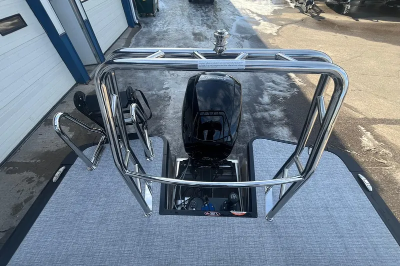 Slide: The Image of 2026 Harris Cruiser 230 CWDH pontoon boat with sleek chrome railing and powerful outboard motor. - 20