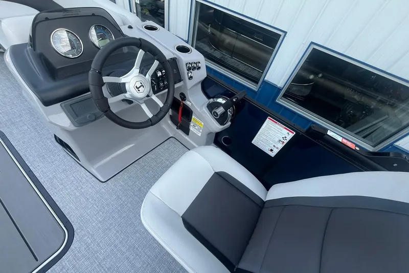 Slide: The Image of 2026 Harris Cruiser 230 CWDH boat interior with steering wheel and dashboard controls. - 21