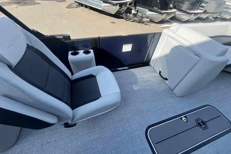 Slide: The Image of Interior of 2026 Harris Cruiser 230 CWDH pontoon boat with seating and cup holders. - 24