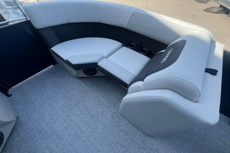 Slide: The Image of 2026 Harris Cruiser 230 CWDH boat interior with plush seating and cup holders. - 27