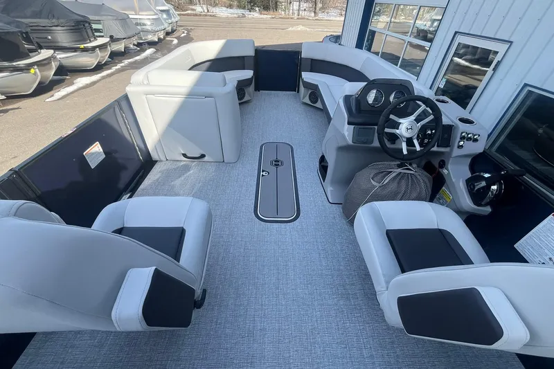Slide: The Image of 2026 Harris Cruiser 230 CWDH pontoon boat interior with modern seating and steering console. - 28