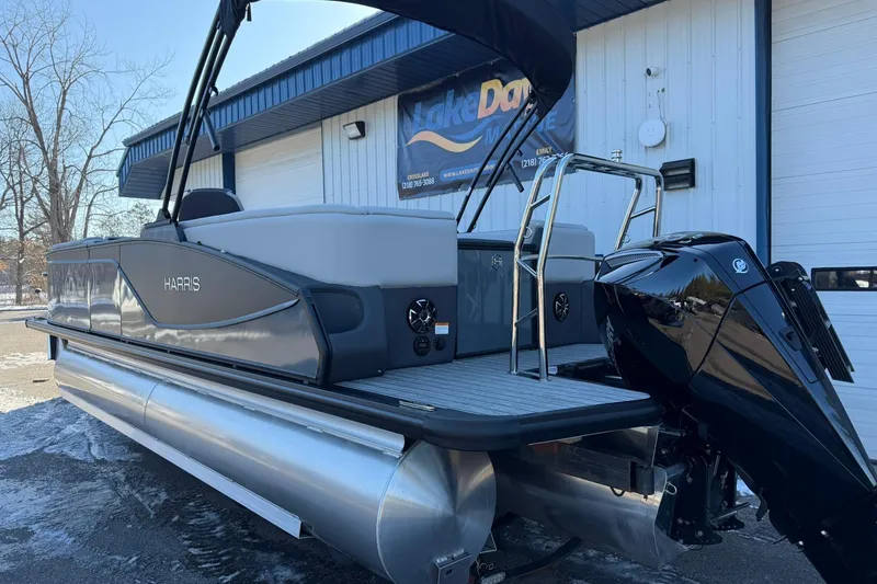 Slide: The Image of 2026 Harris Sunliner 230 pontoon boat with sleek design and powerful outboard motor. - 15
