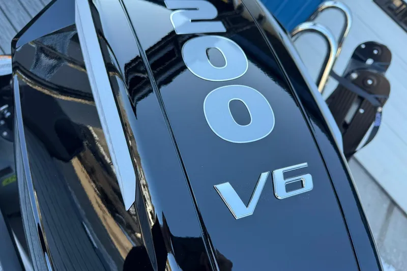 Slide: The Image of Close-up of a 200 V6 engine on a 2026 Harris Sunliner 230 boat. - 17