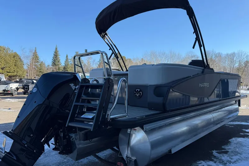 Slide: The Image of 2026 Harris Sunliner 230 pontoon boat with sleek design and powerful outboard motor. - 18