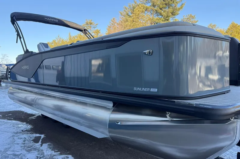 Slide: The Image of 2026 Harris Sunliner 230 pontoon boat with sleek gray design, parked on snowy ground. - 20