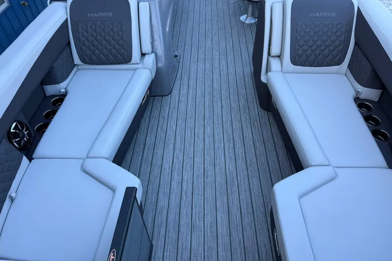 Slide: The Image of Luxurious seating on 2026 Harris Sunliner 230 boat with quilted upholstery and cup holders. - 22