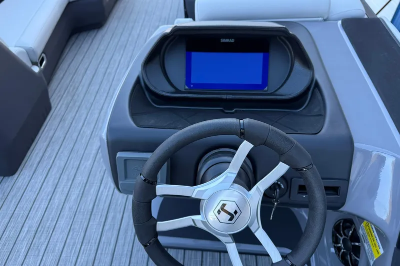 Slide: The Image of Steering console of 2026 Harris Sunliner 230 boat with modern controls and display. - 26