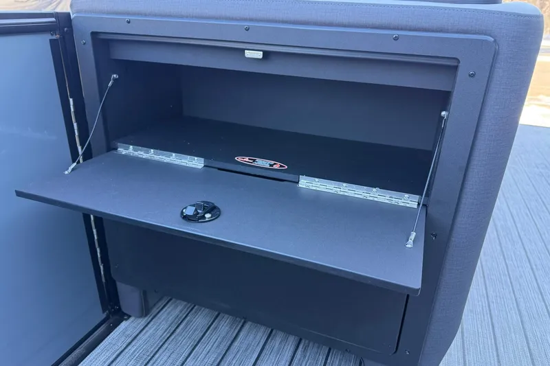 Slide: The Image of Open storage compartment on 2026 Harris Sunliner 230 boat, featuring a sleek design. - 32