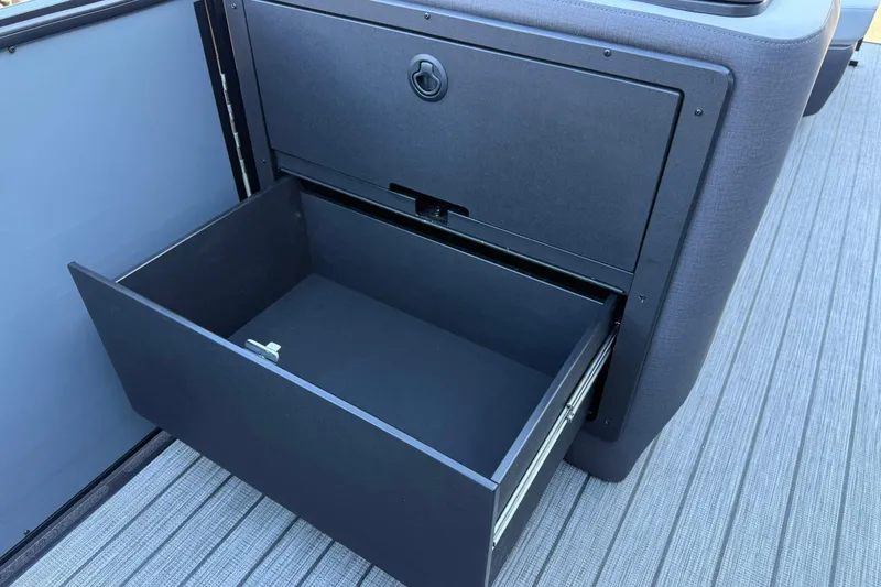Slide: The Image of Open storage drawer on 2026 Harris Sunliner 230 boat, showcasing sleek design and functionality. - 33