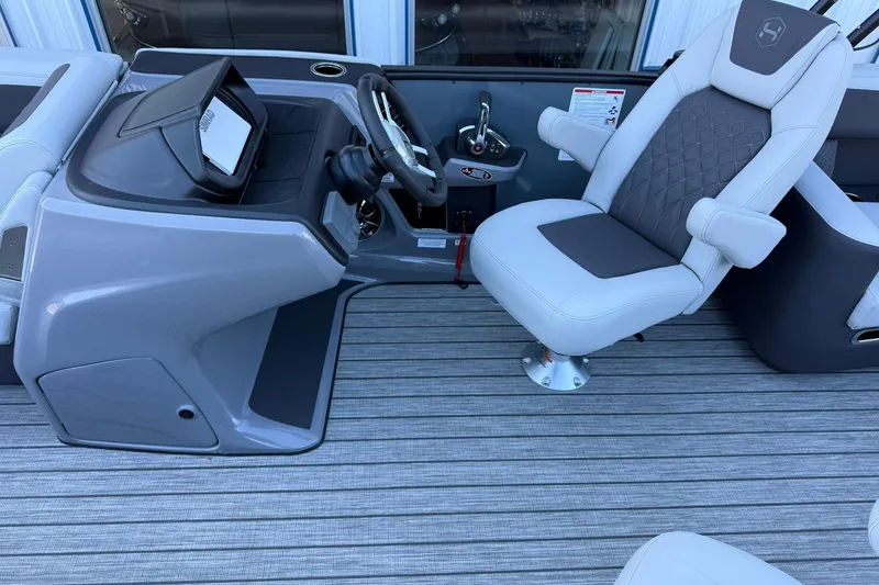 Slide: The Image of 2026 Harris Sunliner 230 boat interior with modern helm and comfortable captain's chair. - 34