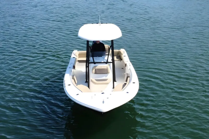 Slide: The Image of 2019 Tidewater 220 LXF boat on calm water, viewed from the front. - 13
