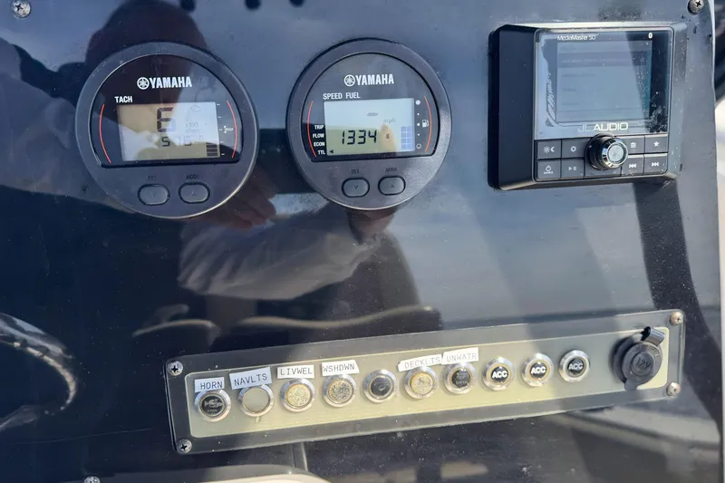 Slide: The Image of Dashboard of a 2019 Tidewater 220 LXF boat with Yamaha gauges and JL Audio system. - 23