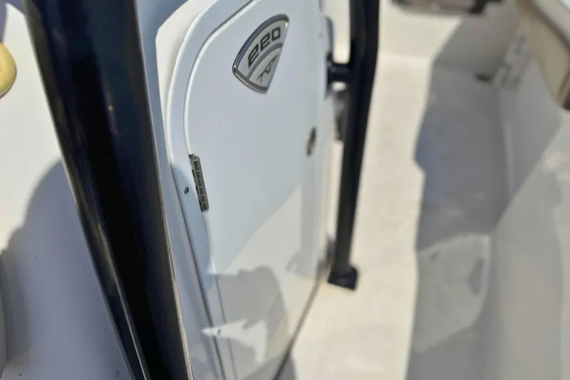 Slide: The Image of Close-up of a 2019 Tidewater 220 LXF boat interior, showcasing a storage compartment. - 28