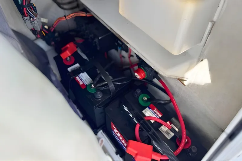 Slide: The Image of 2019 Tidewater 220 LXF boat battery compartment with wiring and connections. - 30