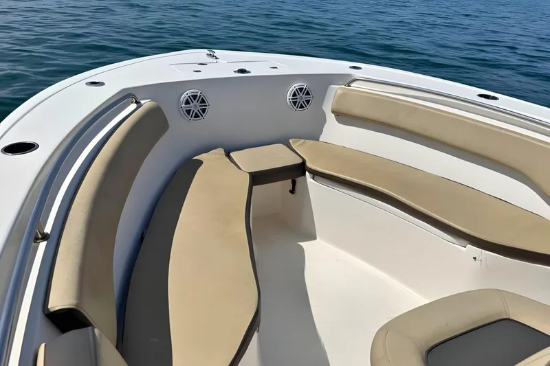 Slide: The Image of 2019 Tidewater 220 LXF boat interior with beige seating and ocean backdrop. - 31