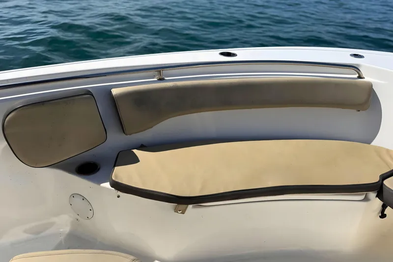 Slide: The Image of 2019 Tidewater 220 LXF boat interior with beige seating and ocean backdrop. - 33