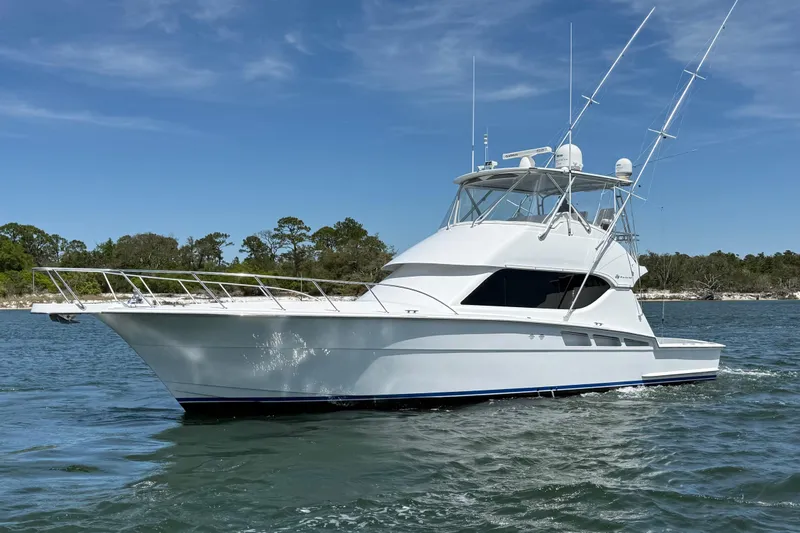 The Image of 2006 Hatteras 50 Convertible yacht cruising on a sunny day. - 0