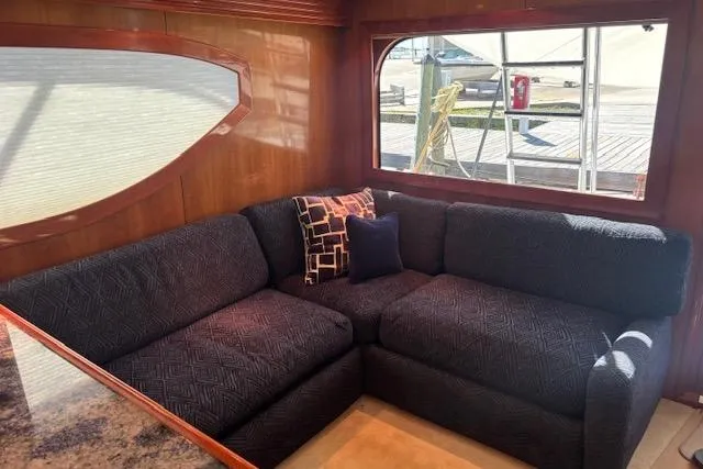 Slide: The Image of Luxurious interior of 2006 Hatteras 50 Convertible yacht with plush navy sofa and decorative pillows. - 14