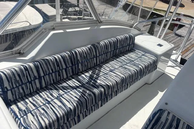 Slide: The Image of 2006 Hatteras 50 Convertible yacht with striped seating on deck. - 15