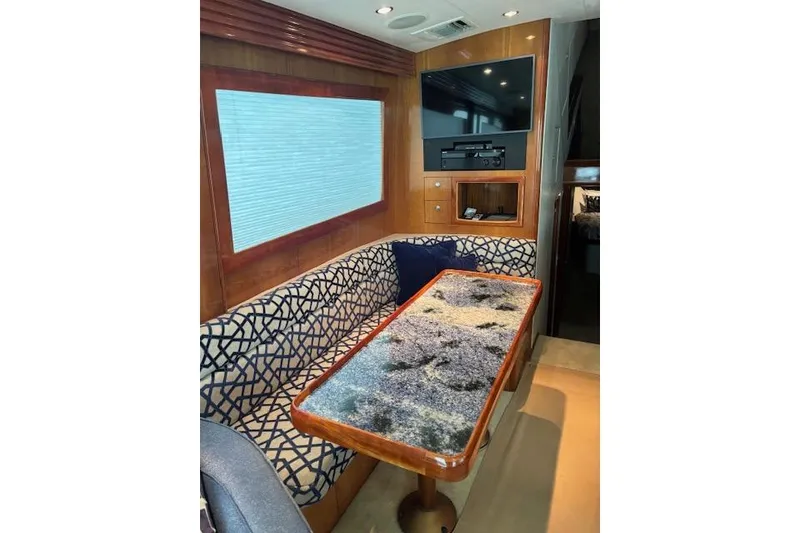 Slide: The Image of Interior of 2006 Hatteras 50 Convertible yacht with patterned seating and modern decor. - 16
