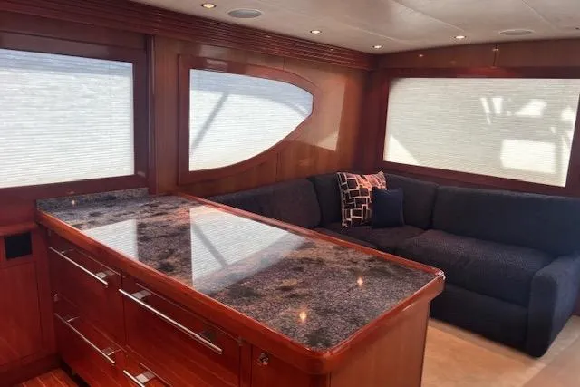 Slide: The Image of Luxurious interior of 2006 Hatteras 50 Convertible yacht with elegant wood finishes and plush seating. - 18