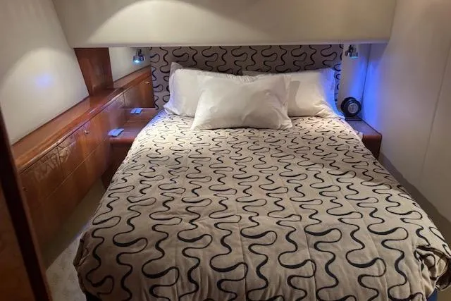 Slide: The Image of Luxurious bedroom interior of 2006 Hatteras 50 Convertible yacht with patterned bedding. - 20