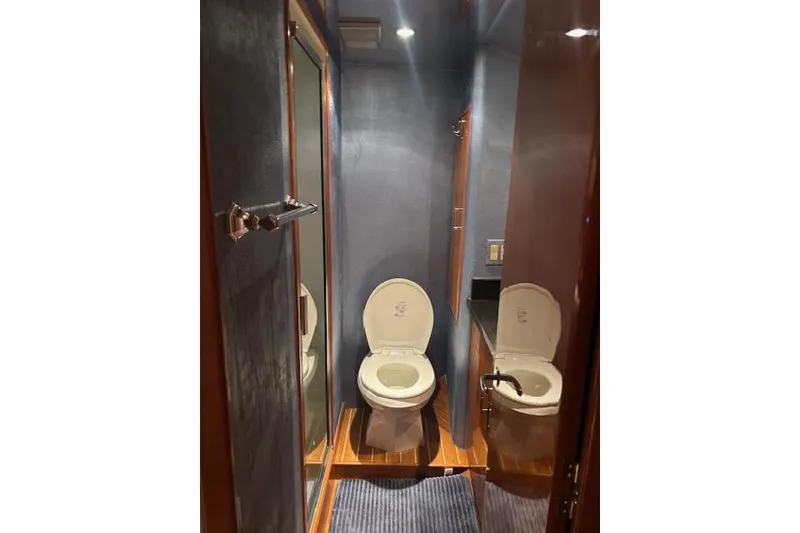 Slide: The Image of Bathroom interior of 2006 Hatteras 50 Convertible yacht, featuring modern fixtures and wood accents. - 21