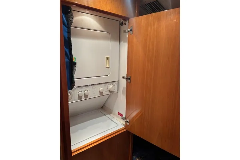 Slide: The Image of Laundry area with stacked washer-dryer in 2006 Hatteras 50 Convertible yacht. - 24