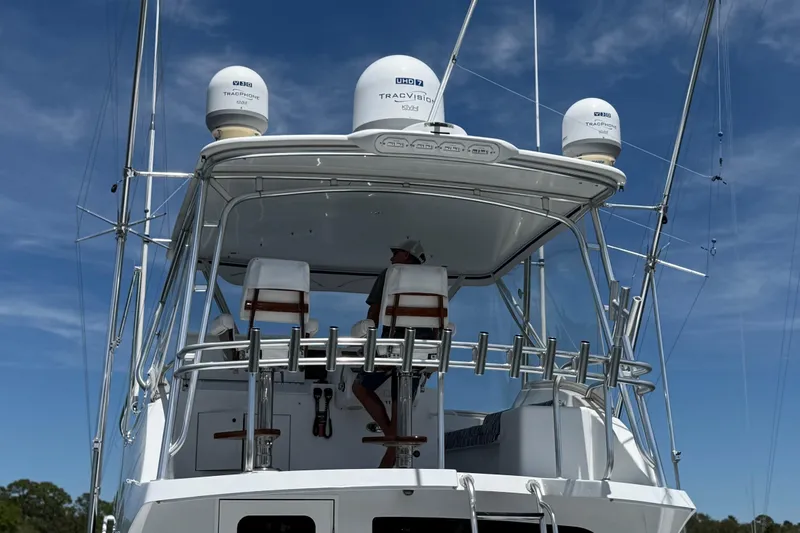 Slide: The Image of 2006 Hatteras 50 Convertible yacht with radar domes and fishing equipment under clear skies. - 9