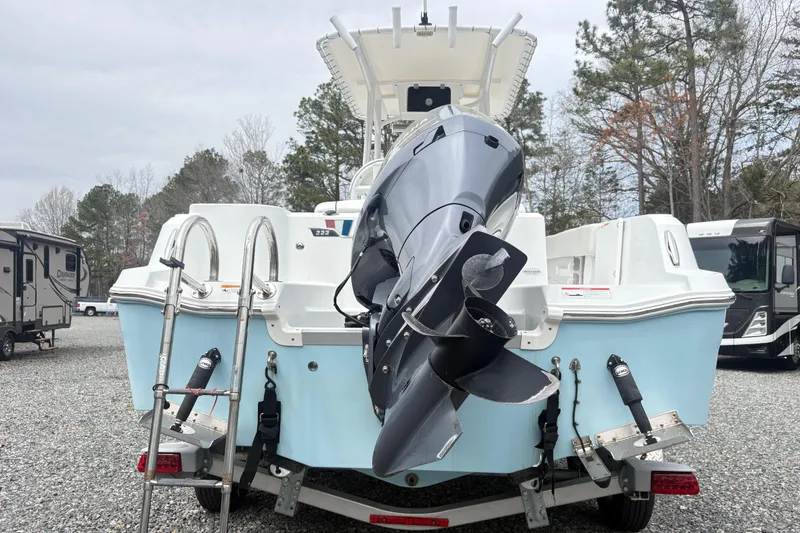 Slide: The Image of 2022 Wellcraft 222 Fisherman boat on trailer, featuring powerful outboard motor. - 10