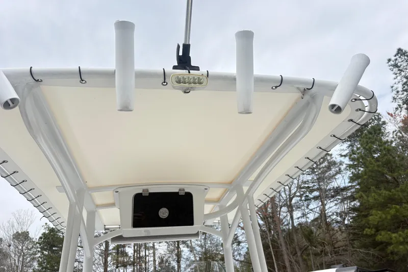 Slide: The Image of T-top of 2022 Wellcraft 222 Fisherman boat with rod holders and LED light. - 13