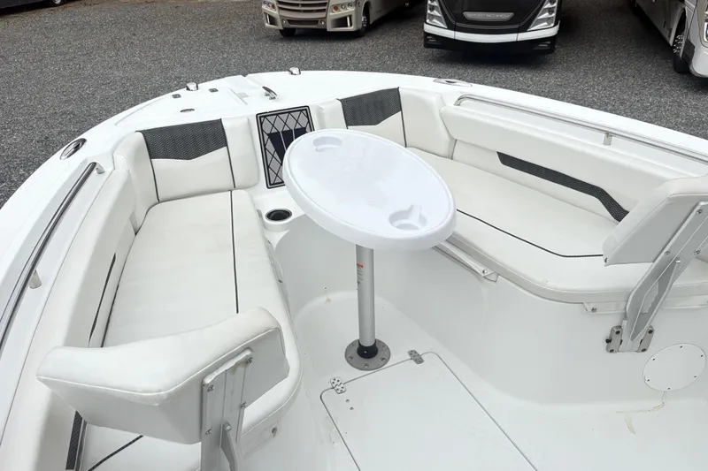 Slide: The Image of 2022 Wellcraft 222 Fisherman boat interior with white seating and a central table. - 17