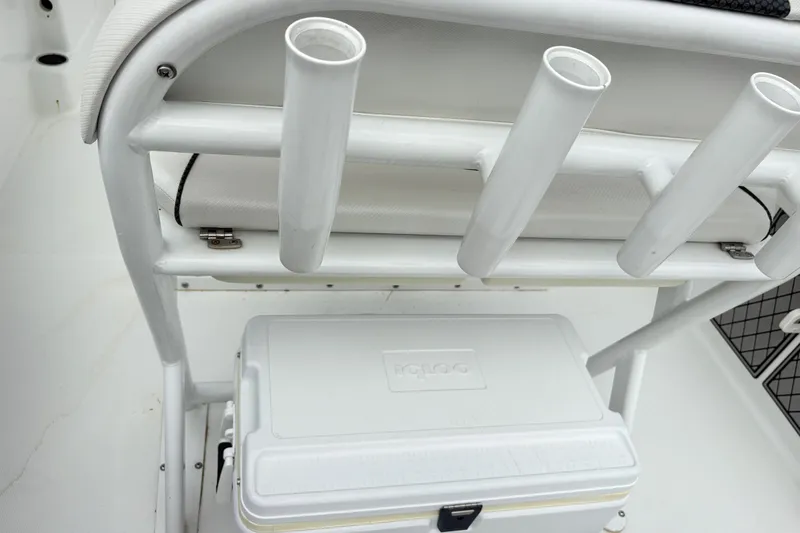 Slide: The Image of 2022 Wellcraft 222 Fisherman boat with rod holders and cooler storage. - 6