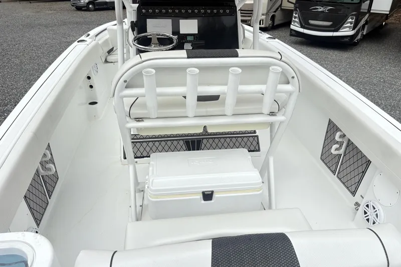Slide: The Image of 2022 Wellcraft 222 Fisherman boat interior with rod holders and storage compartments. - 8