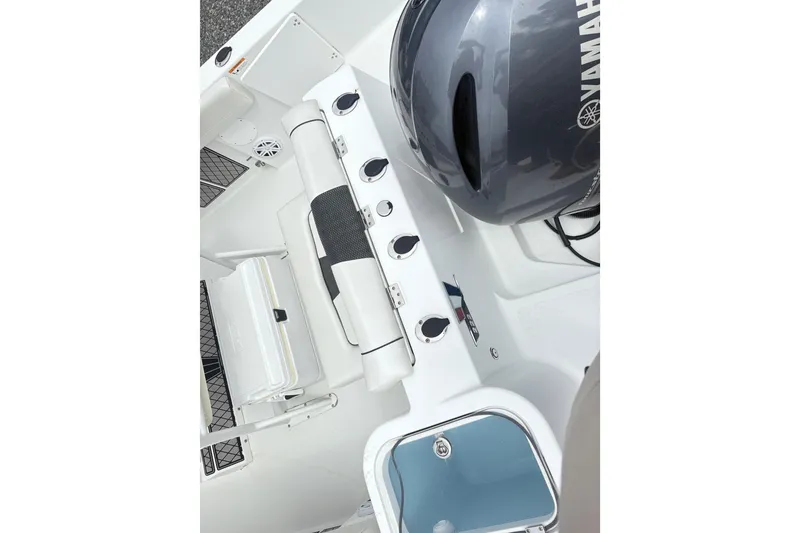 Slide: The Image of 2022 Wellcraft 222 Fisherman boat interior with Yamaha engine, featuring seating and storage compartments. - 9