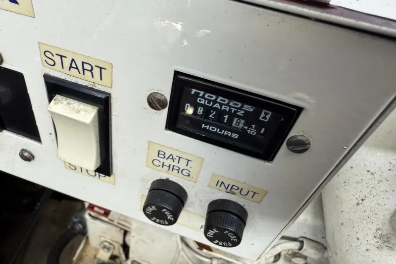 Slide: The Image of Control panel of a 1994 Formula 419 SR-1 boat with hour meter and switches. - 11