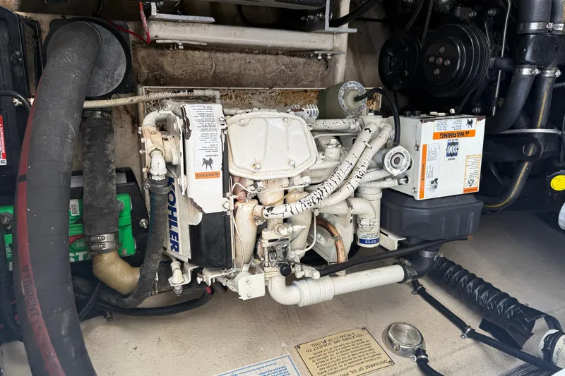 Slide: The Image of Engine compartment of a 1994 Formula 419 SR-1 boat, featuring Kohler components. - 13