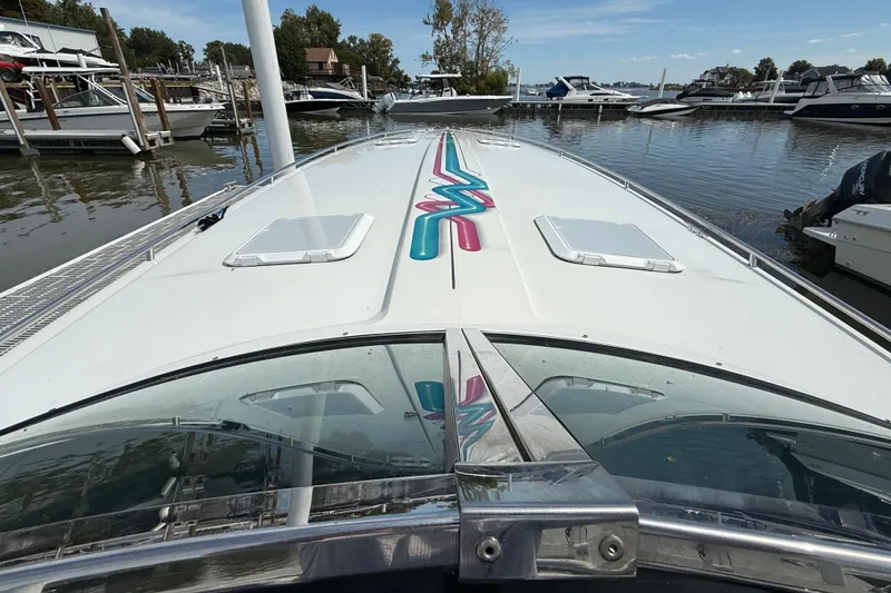 Slide: The Image of 1994 Formula 419 SR-1 boat docked at marina, showcasing sleek design and vibrant graphics. - 18