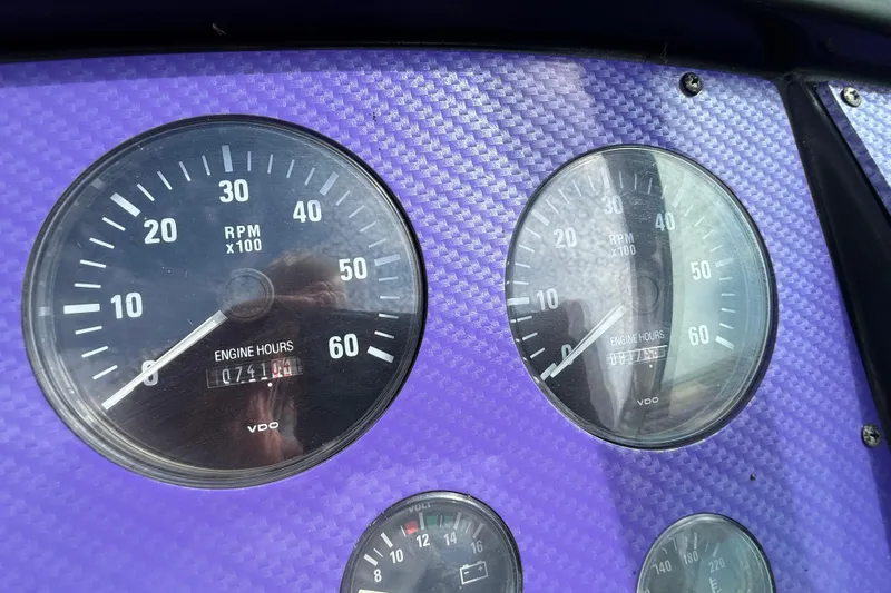 Slide: The Image of Dashboard of a 1994 Formula 419 SR-1 with RPM gauges on purple carbon fiber background. - 21