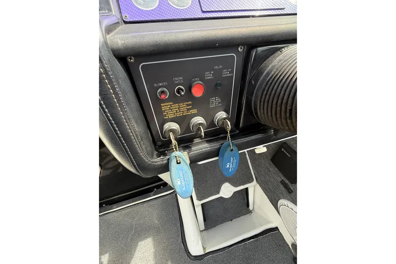 Slide: The Image of Control panel of a 1994 Formula 419 SR-1 boat with ignition keys and switches. - 23
