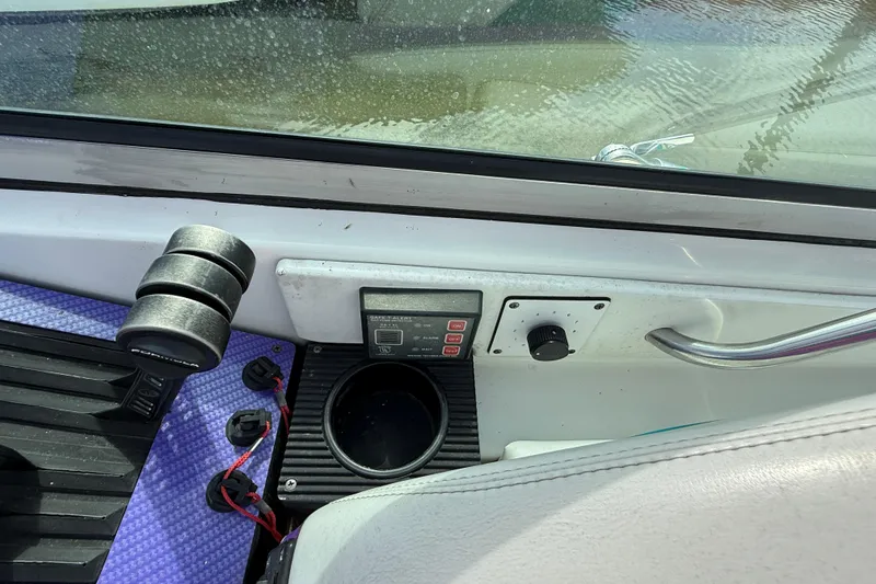 Slide: The Image of Interior view of a 1994 Formula 419 SR-1 boat dashboard with controls and cup holder. - 24