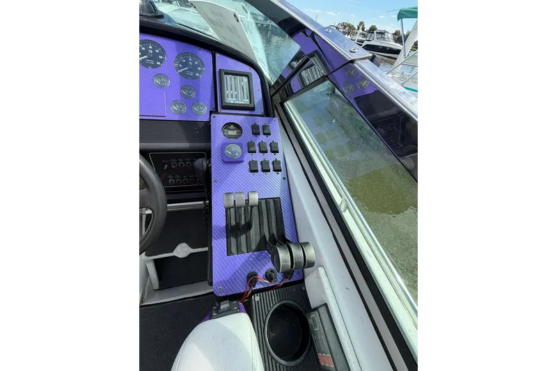 Slide: The Image of Dashboard of a 1994 Formula 419 SR-1 boat with purple accents and control panel. - 25