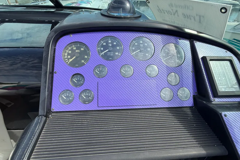 Slide: The Image of Dashboard of a 1994 Formula 419 SR-1 boat with multiple gauges and controls. - 26