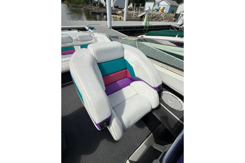 Slide: The Image of Colorful seating on a 1994 Formula 419 SR-1 boat, docked by the water. - 27