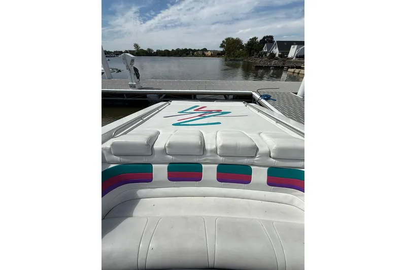 Slide: The Image of 1994 Formula 419 SR-1 boat interior with colorful upholstery, docked by a serene lake. - 30