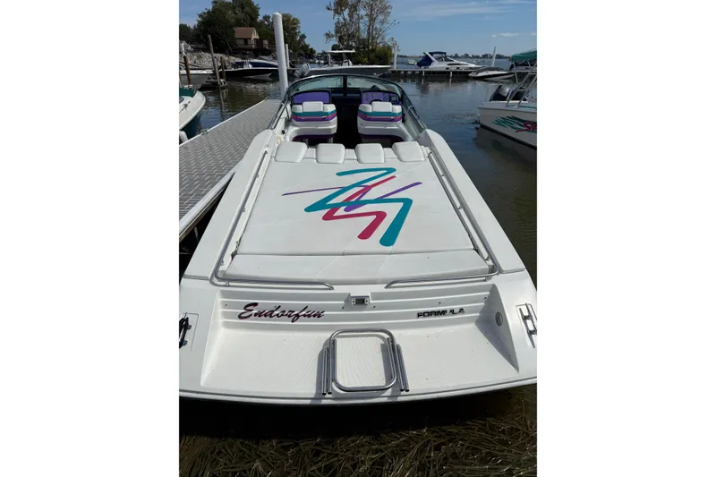 Slide: The Image of 1994 Formula 419 SR-1 speedboat docked, featuring colorful graphics and sleek design. - 31