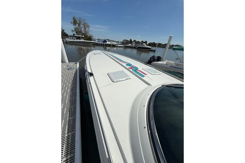 Slide: The Image of 1994 Formula 419 SR-1 boat docked at marina, showcasing sleek design and vibrant graphics. - 5