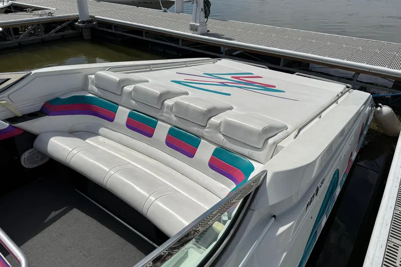 Slide: The Image of 1994 Formula 419 SR-1 boat interior with colorful seating and sleek design at dock. - 6