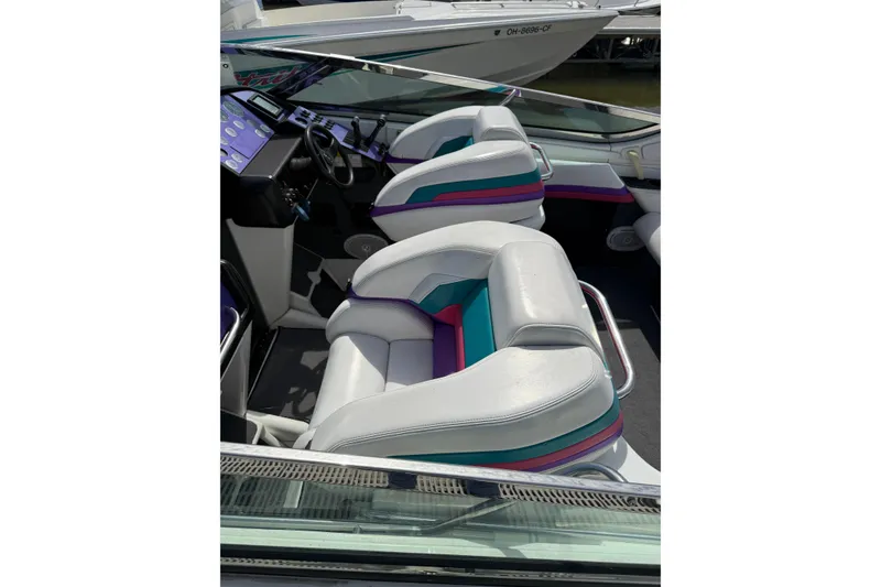 Slide: The Image of 1994 Formula 419 SR-1 boat interior with white and teal seating. - 7
